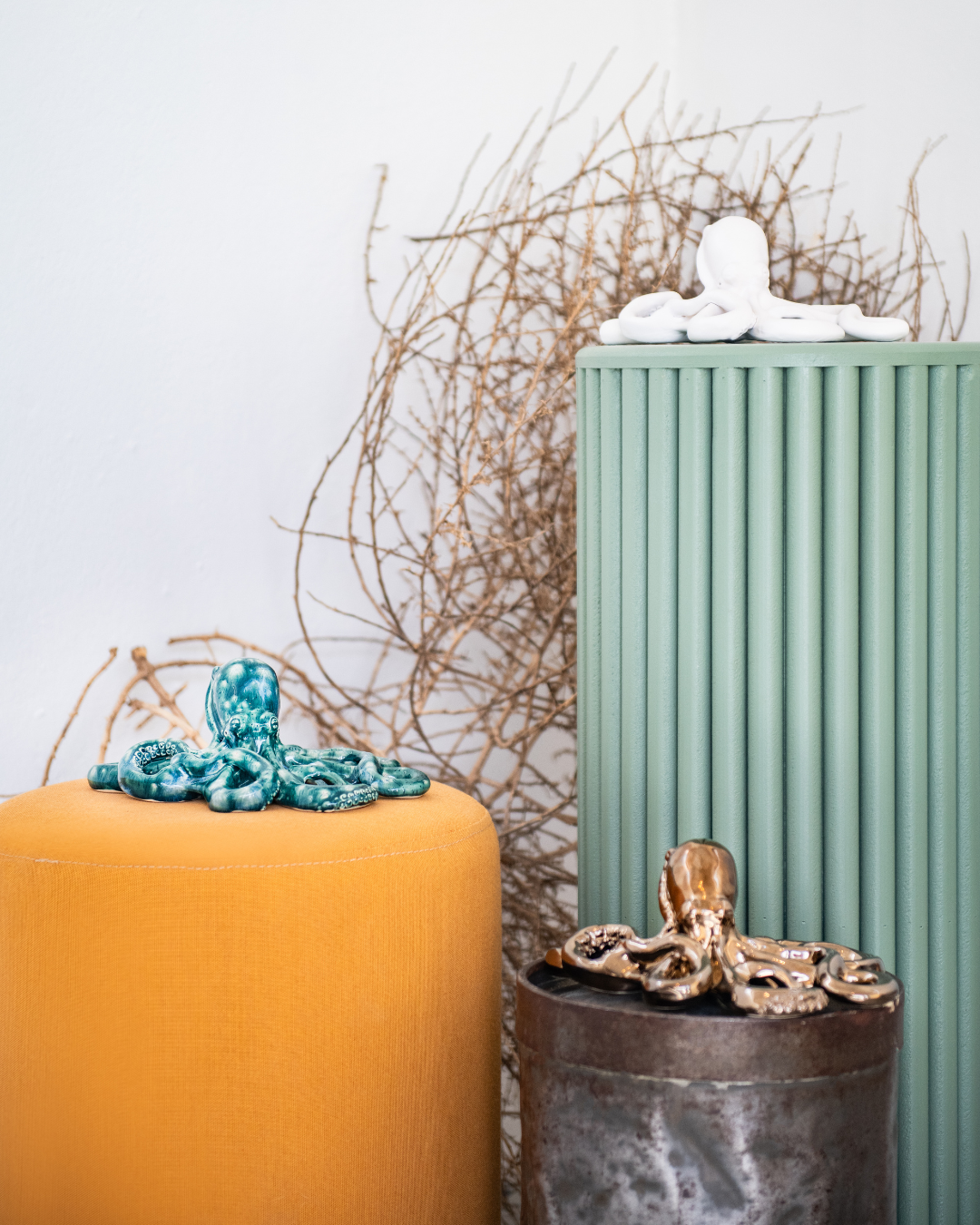 Decorative candles with ocean-themed octopuses' sculptures on a light background