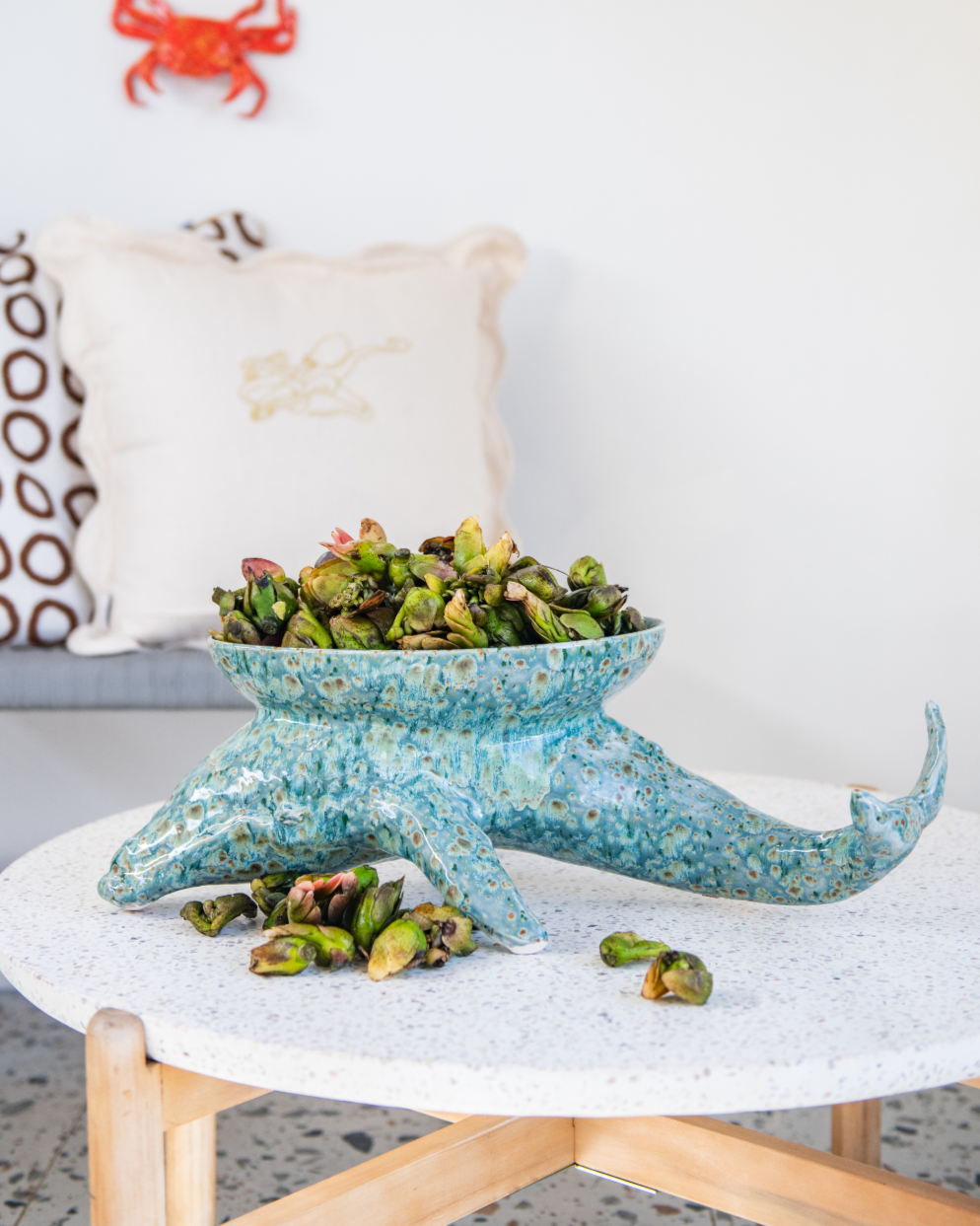 Decorative bowl in ceramic shaped like a Humpback Whale with plants on a table