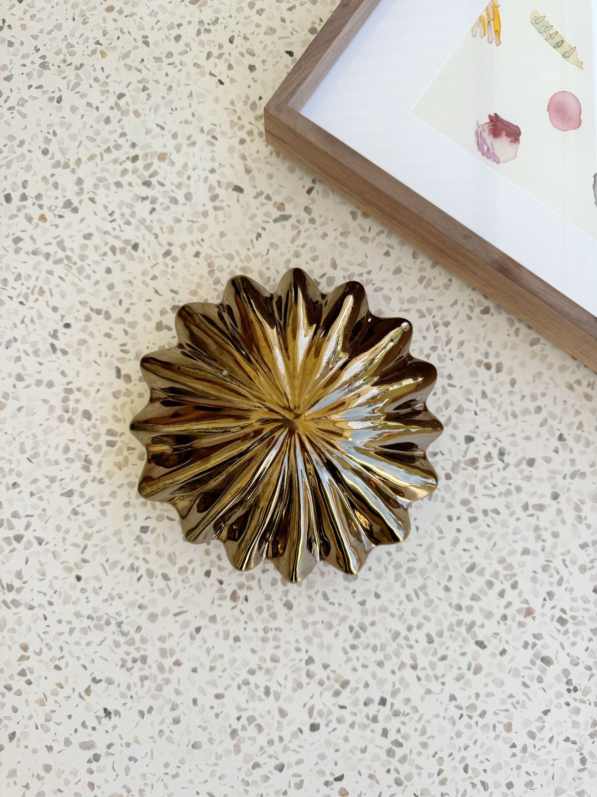 Decorative metallic object on a textured surface with a blurred background