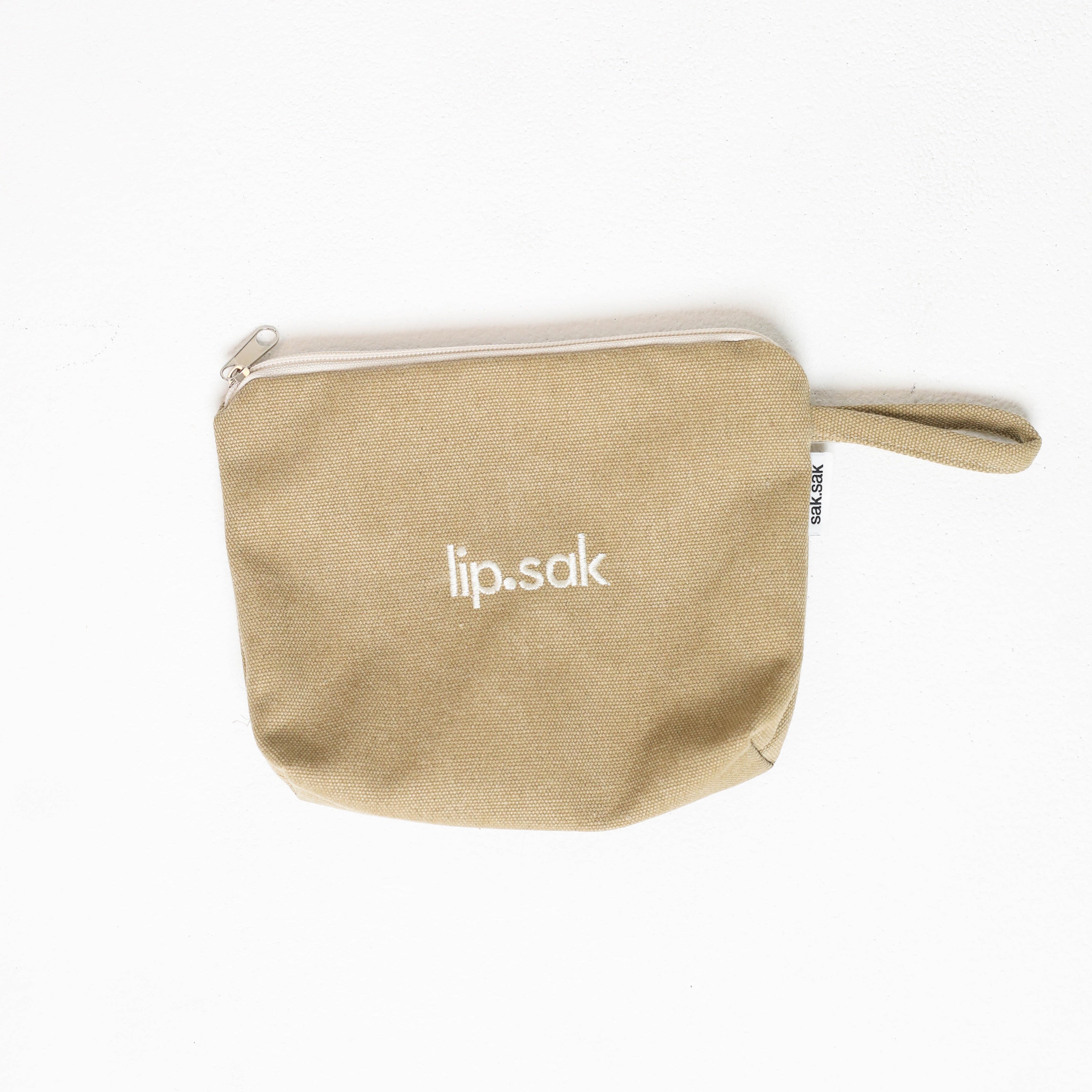 Beige pouch with 'lip.sak' branding on a white background