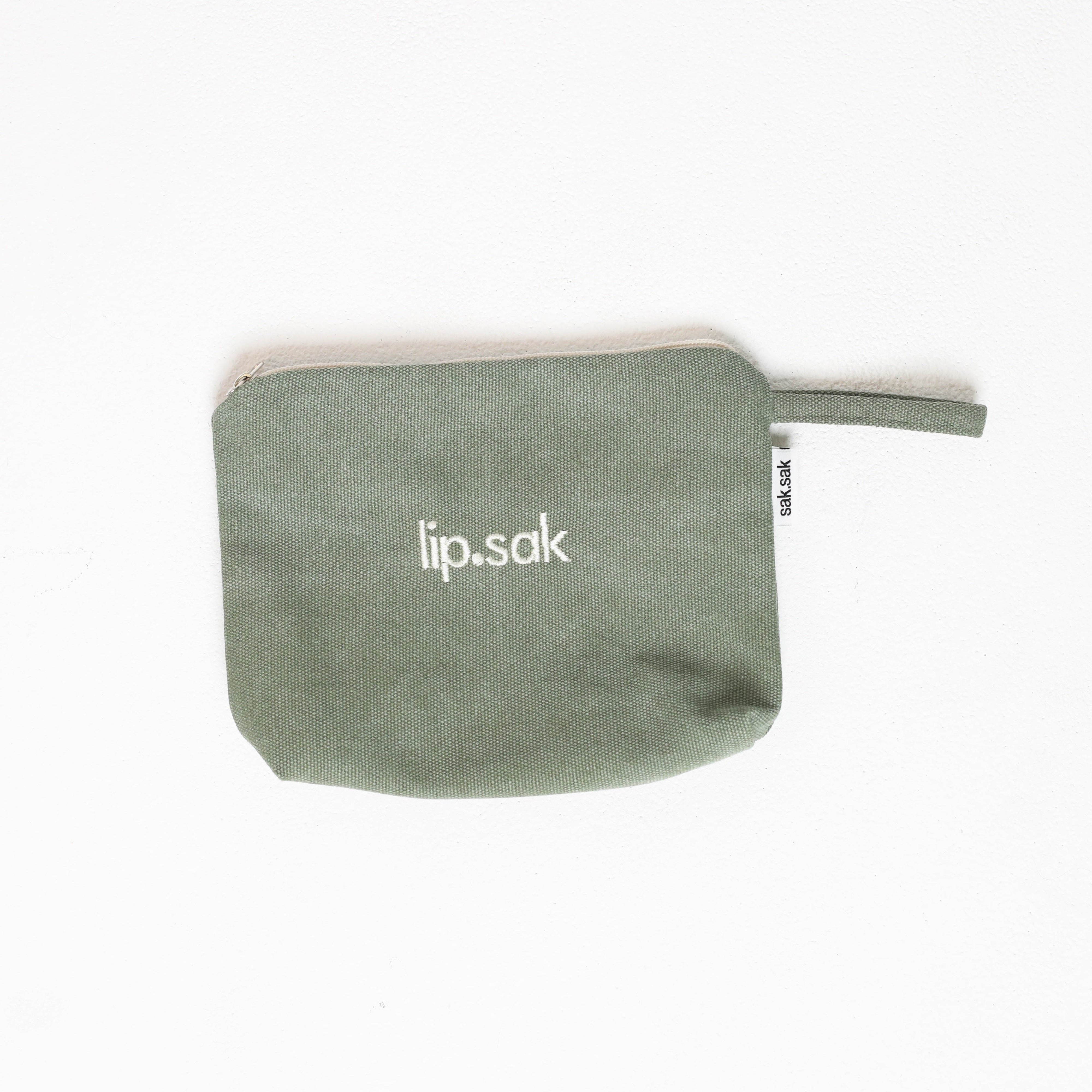 Green pouch with 'lip.sak' branding on a white background