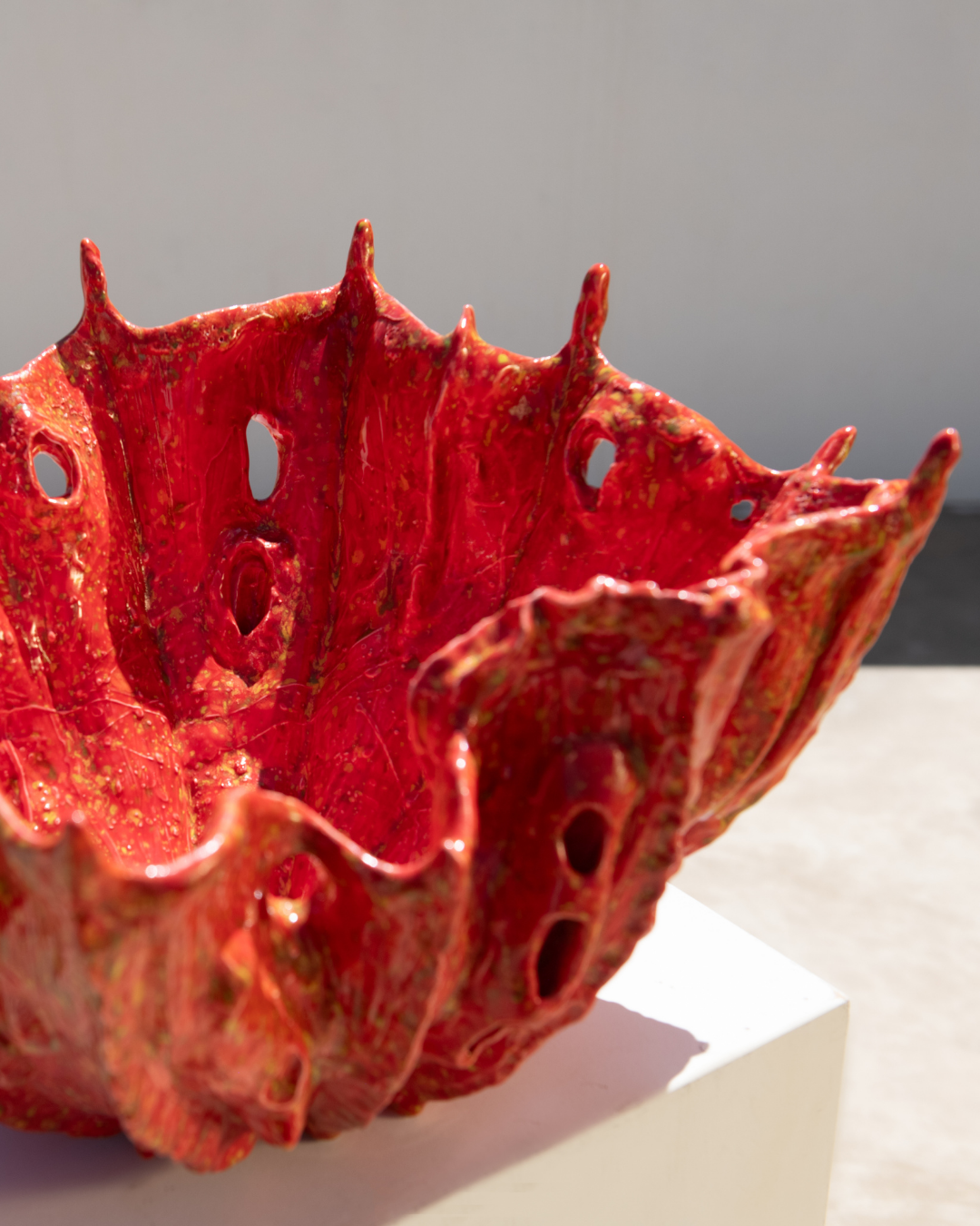 Red ceramic bowl with textured surface on a light background