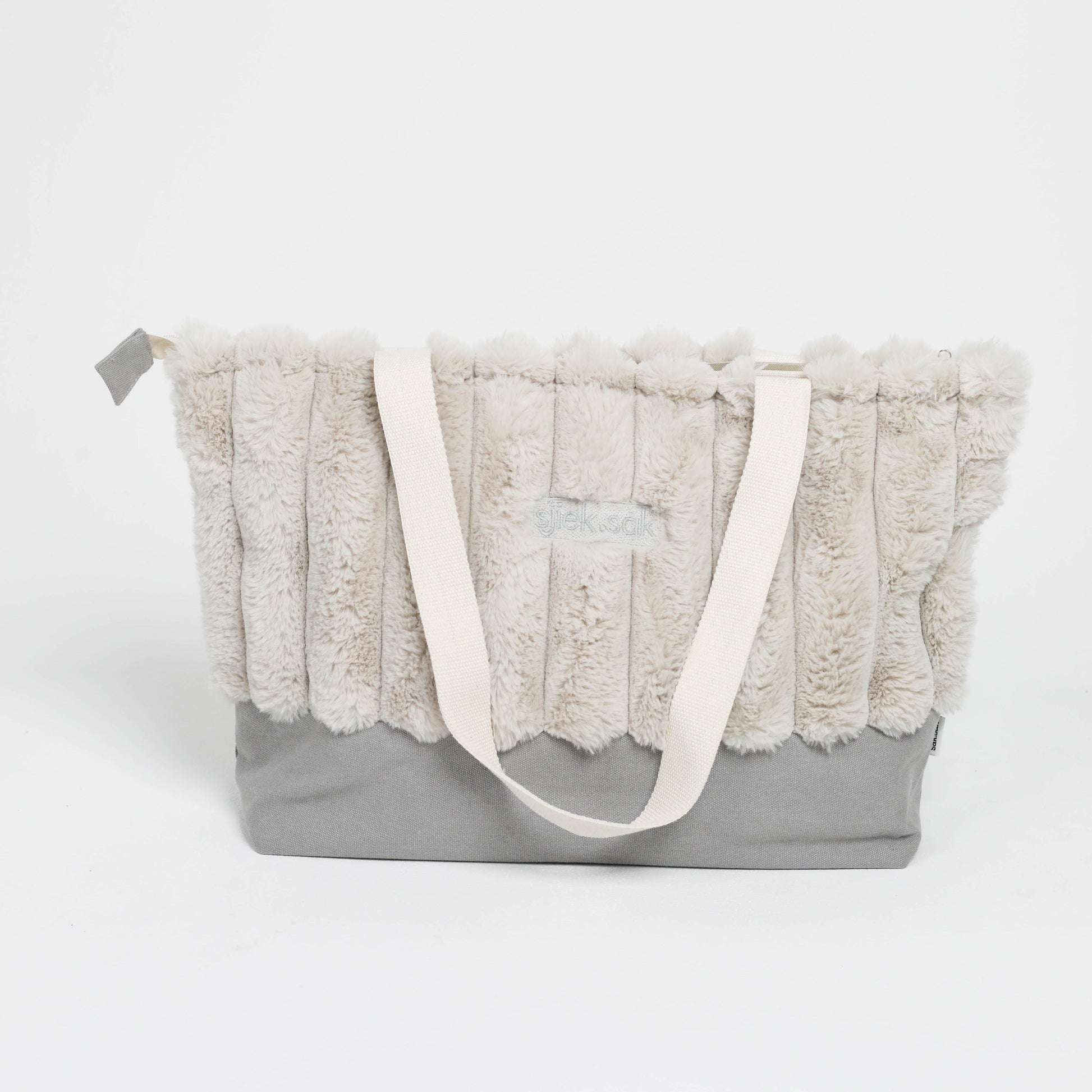 Gray tote bag with textured fabric top and white handle on a white background
