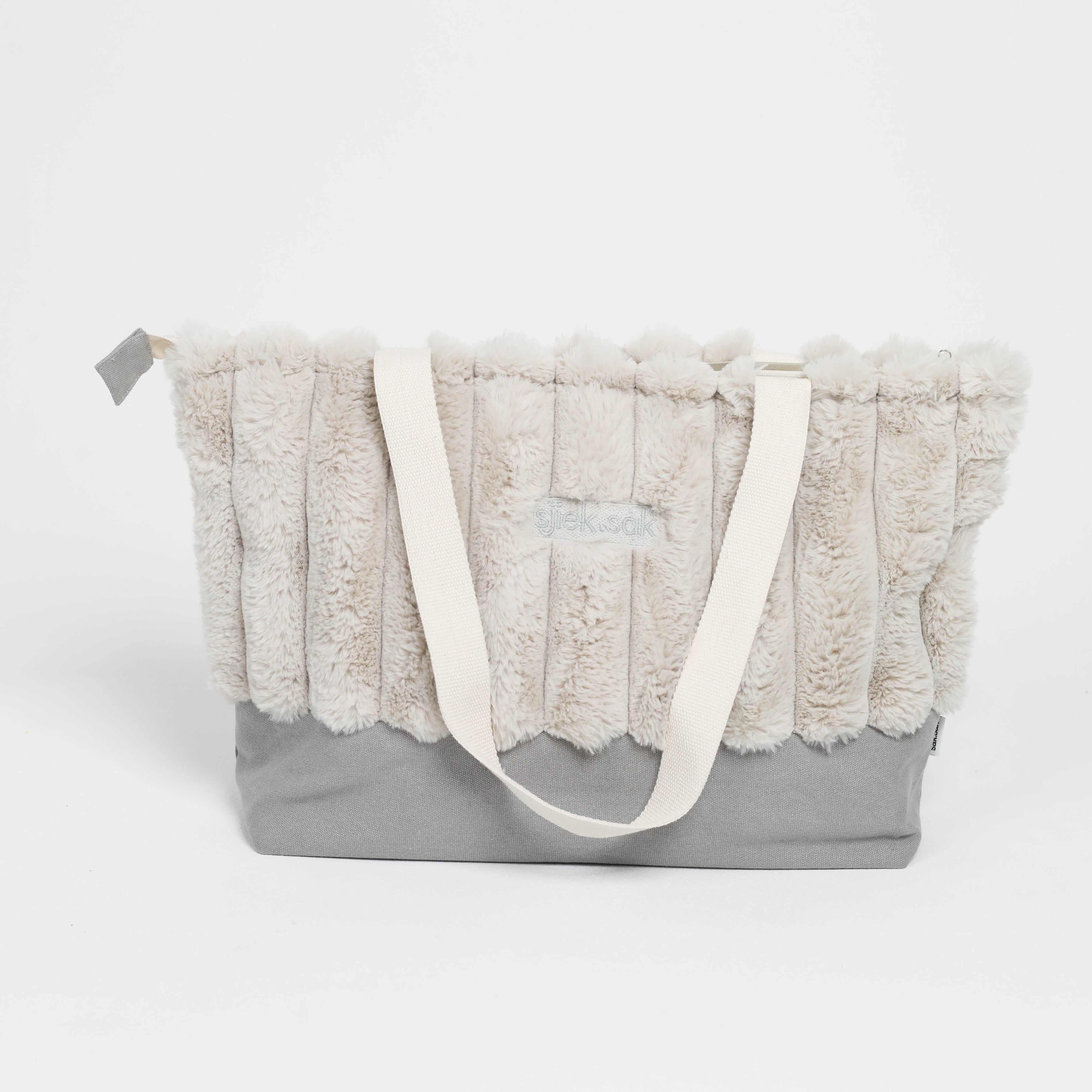 Gray tote bag with textured fabric top and white handle on a white background