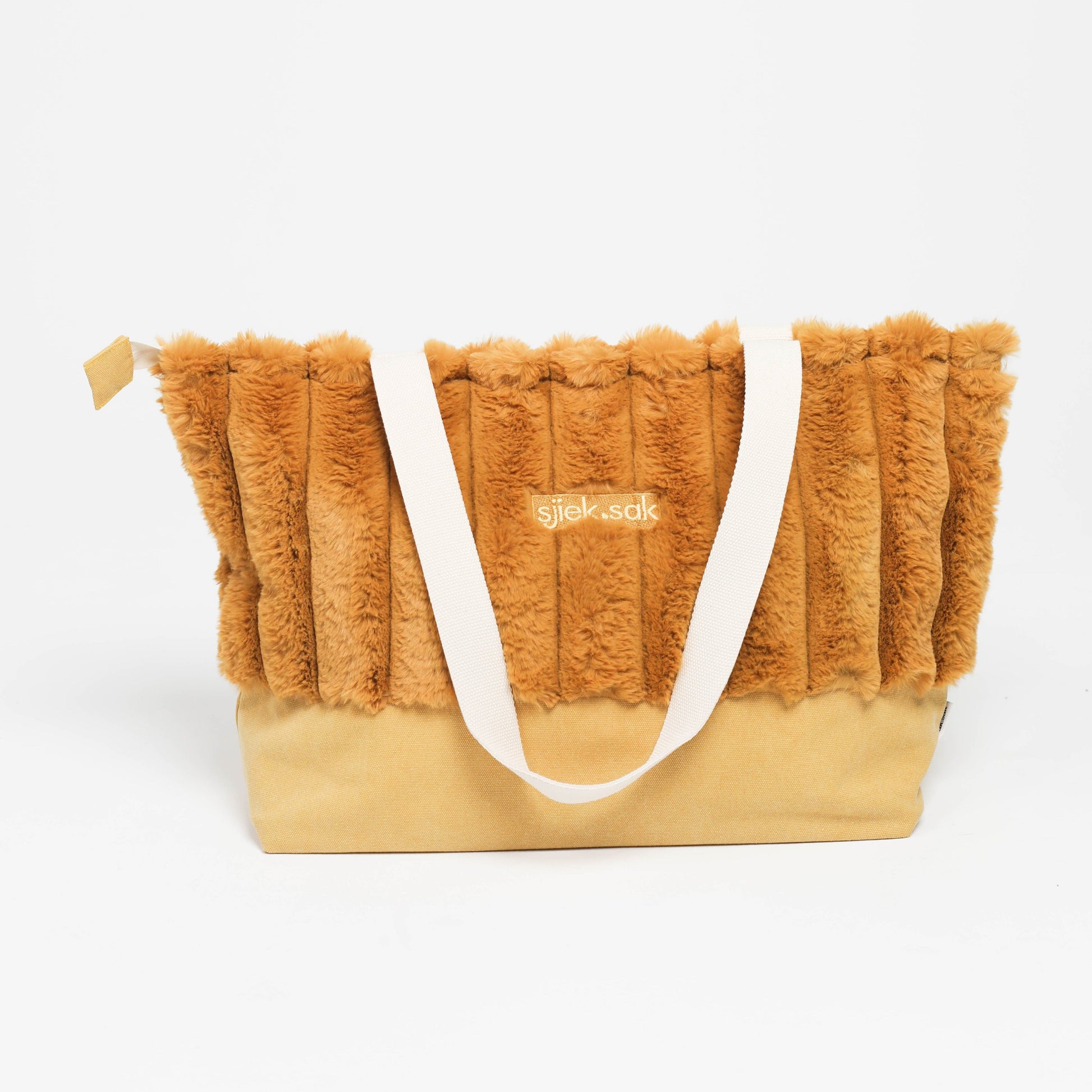 Orange fluffy bag with a white handle on a white background
