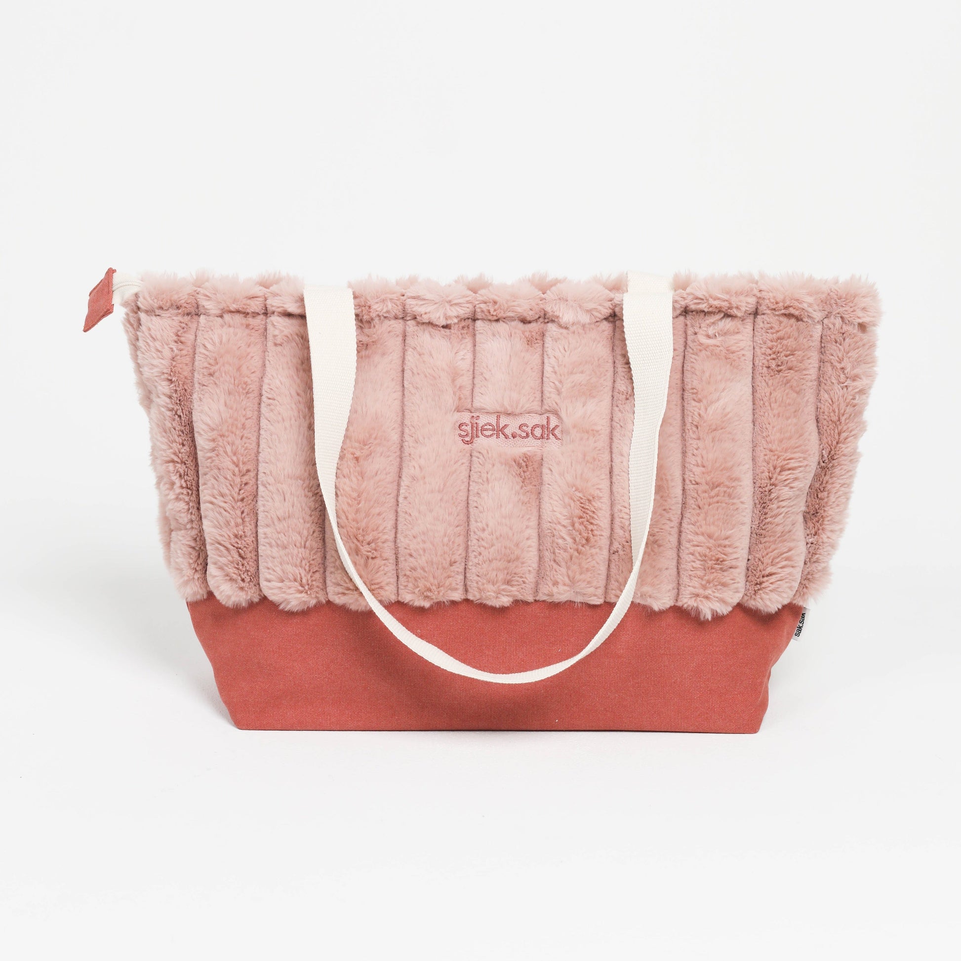 Pink plush tote bag with a visible brand logo on a white background