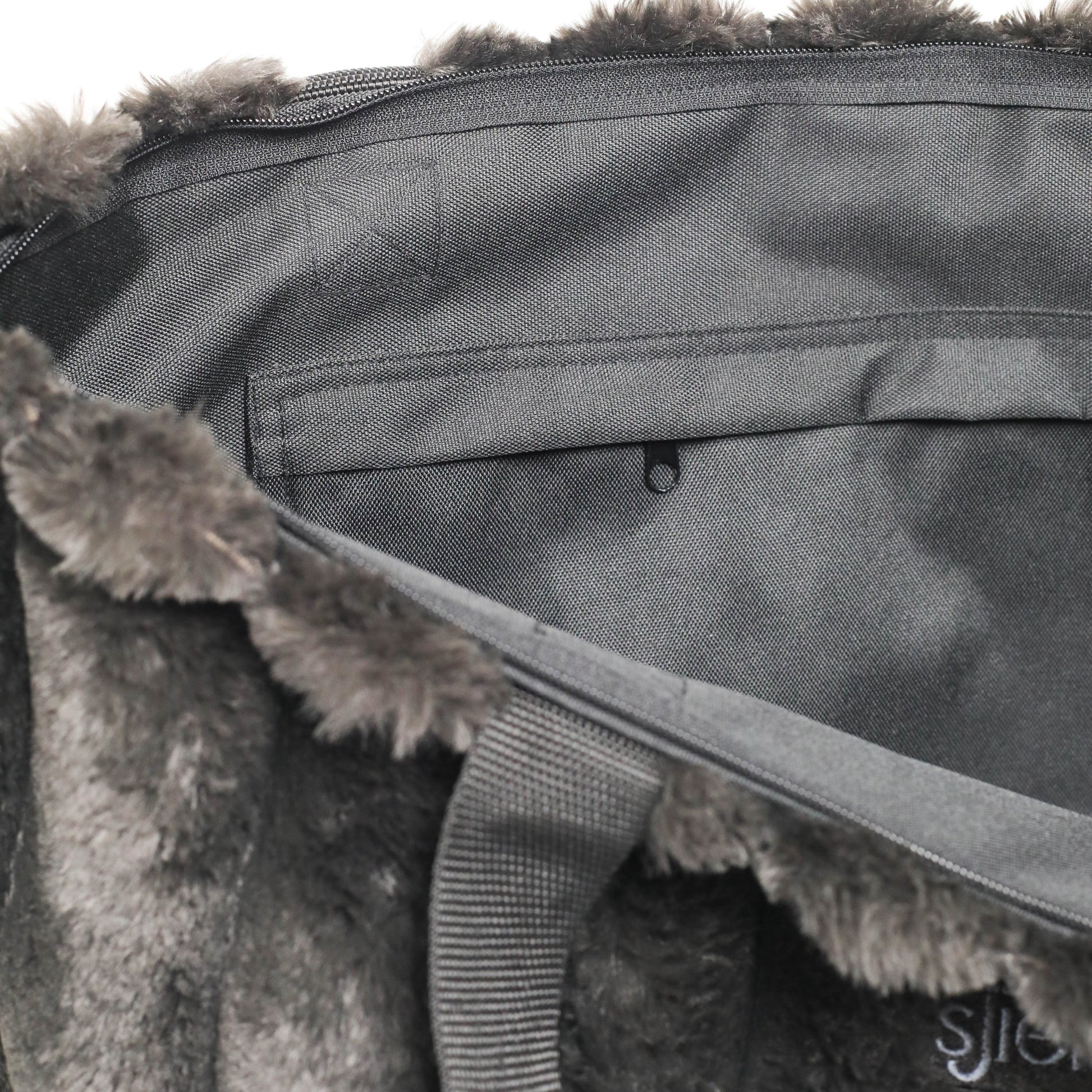 Gray bag with fur trim on a white background