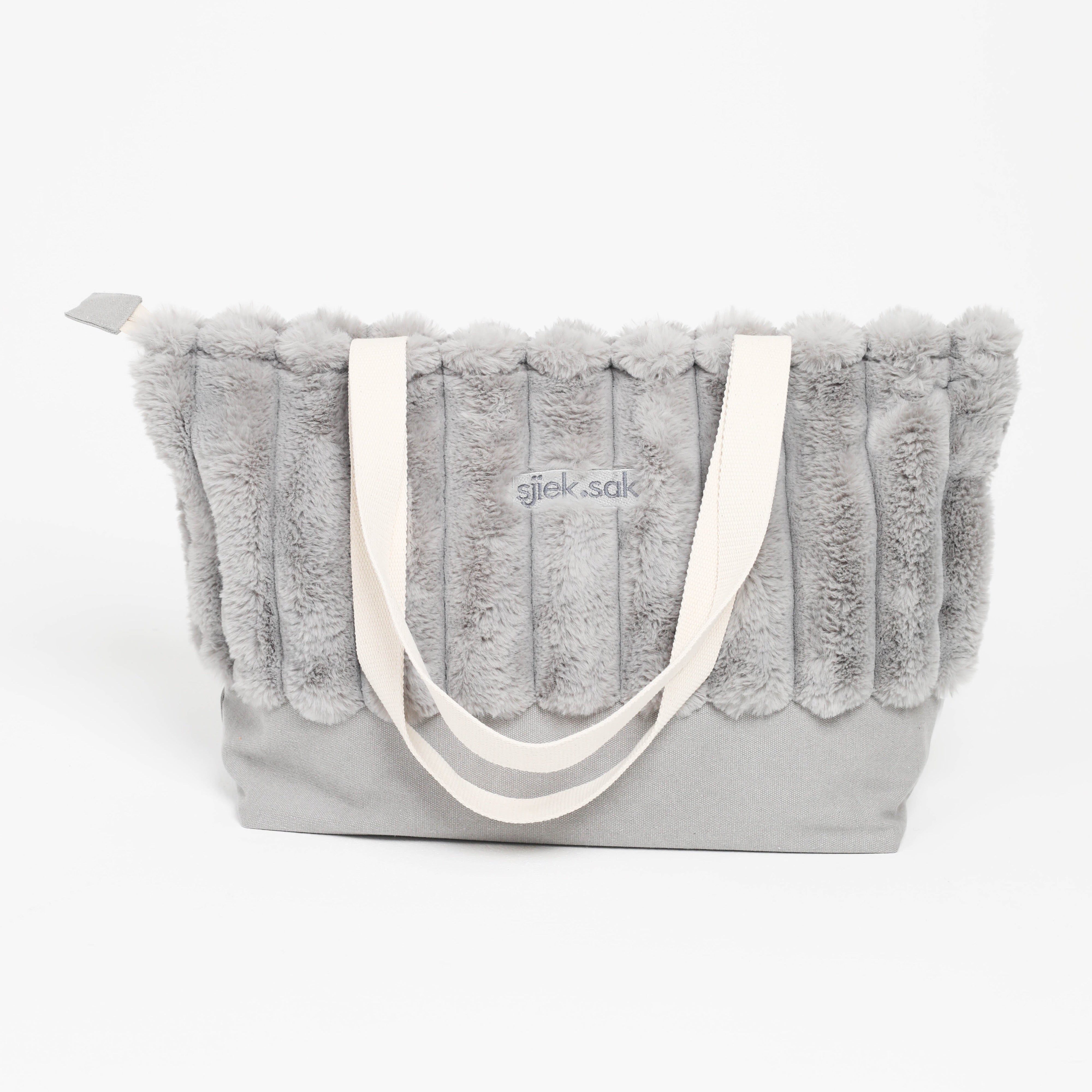 Gray fluffy tote bag with a white handle on a white background