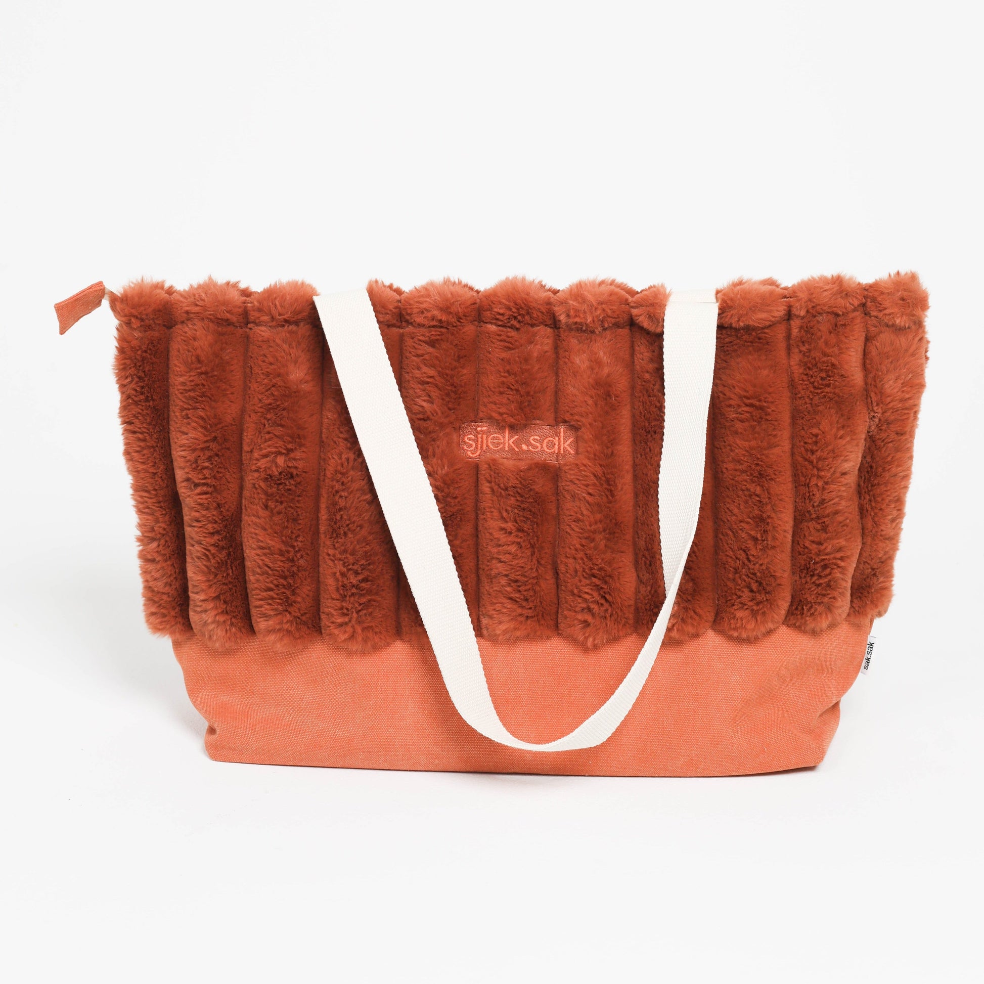Red fluffy bag with a white strap on a white background
