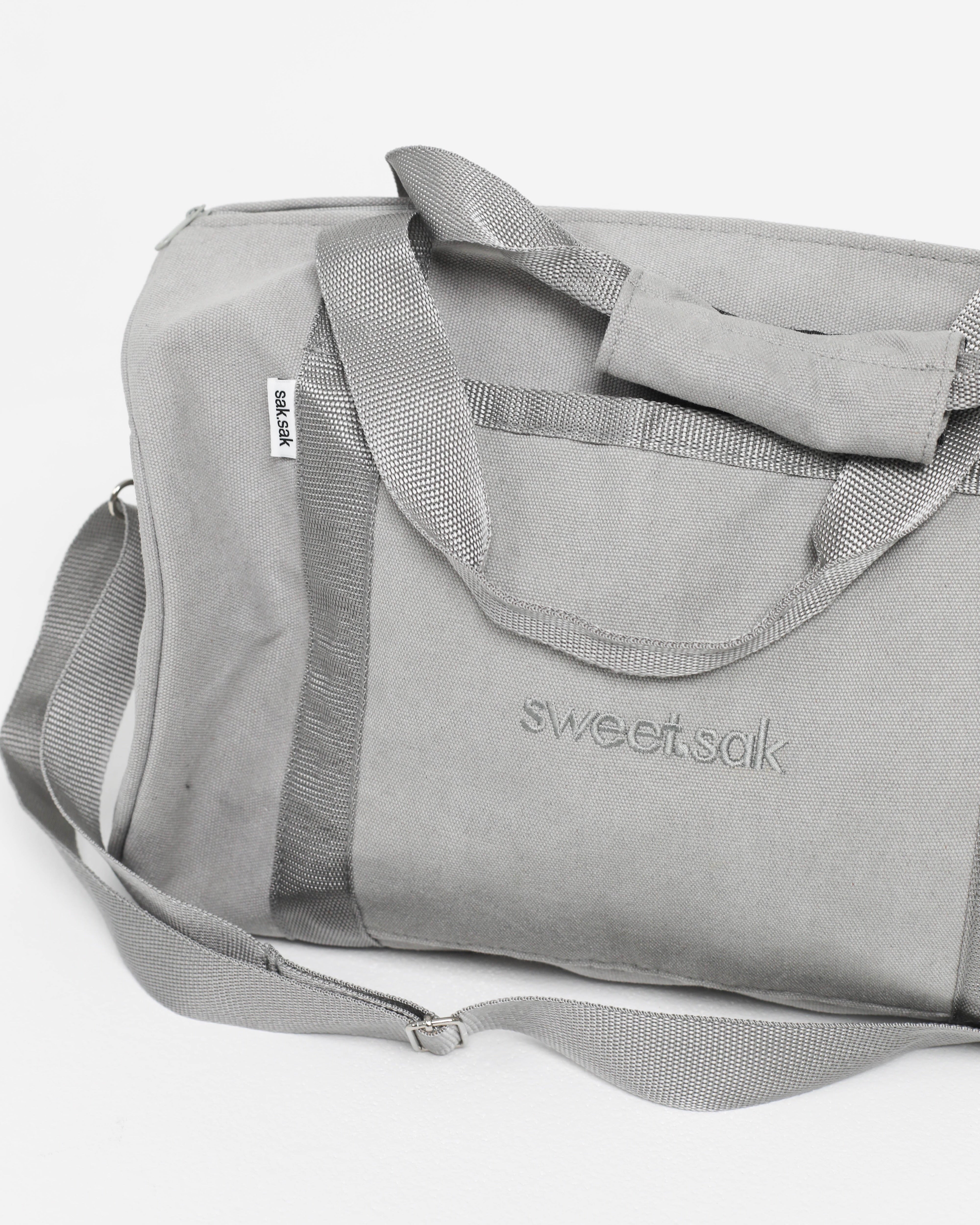 Gray duffel bag with 'sweetsak' branding on a white background