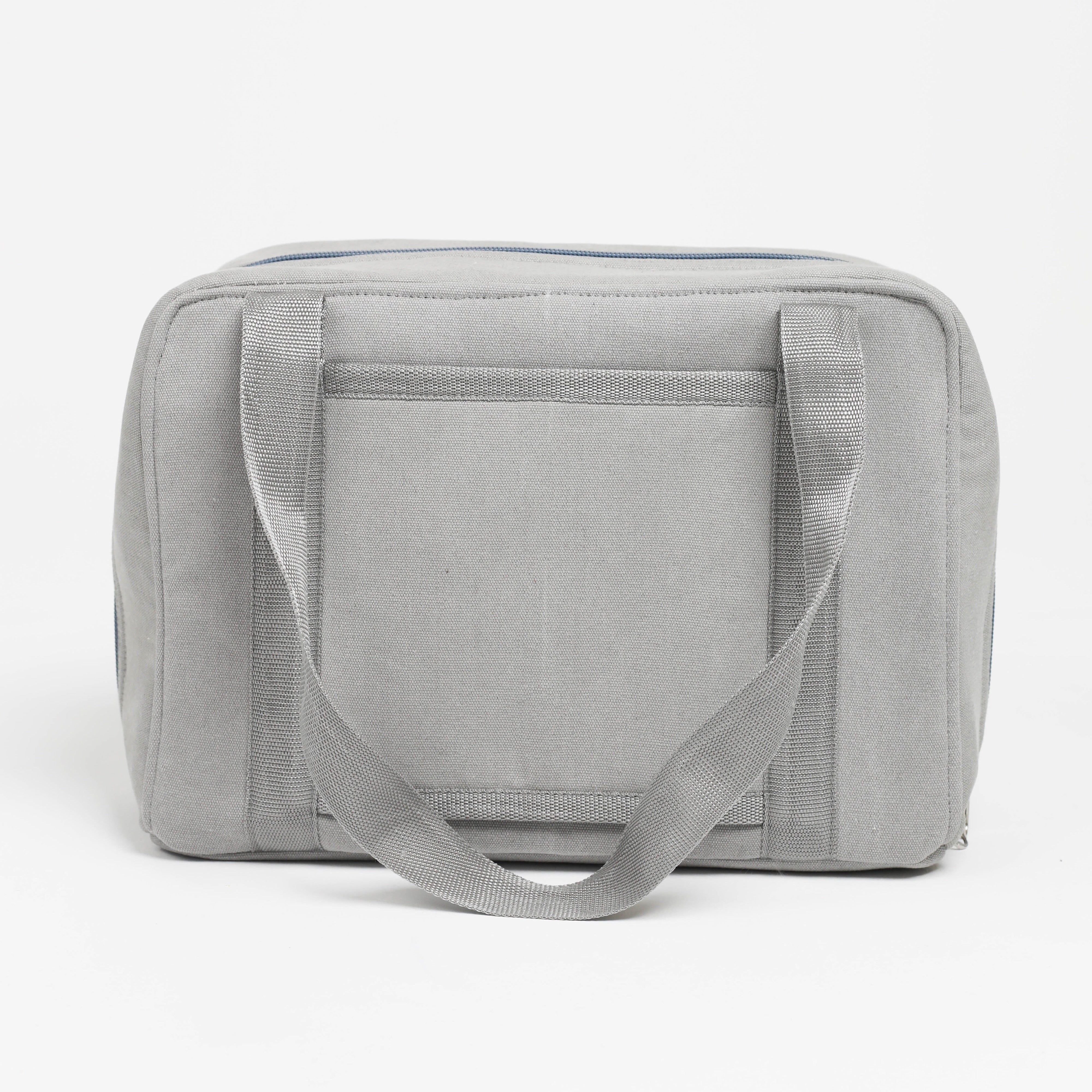Gray toiletry bag with a handle on a white background